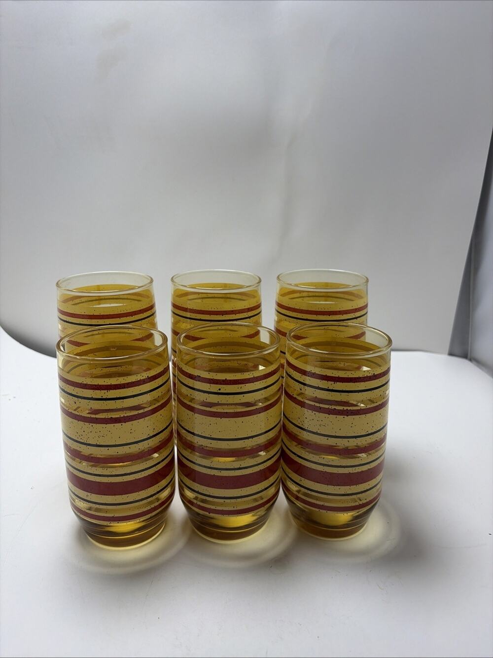 Mid Century Modern amber glass juice tumblers yellow red stripe speckled Anchor